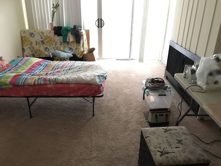 Living room with a bed and a desk