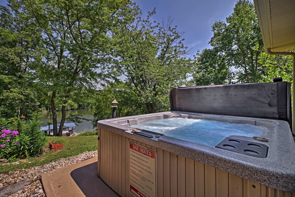 This waterfront property features a private outdoor hot tub and patio!