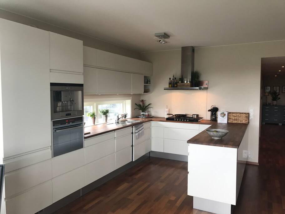 Open kitchen with cooler, small freezer, oven/microwave, gass stove and coffee machine.