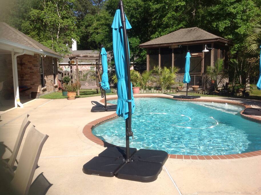 Additional umbrella table & 6 chairs on pool deck, & wooden swing