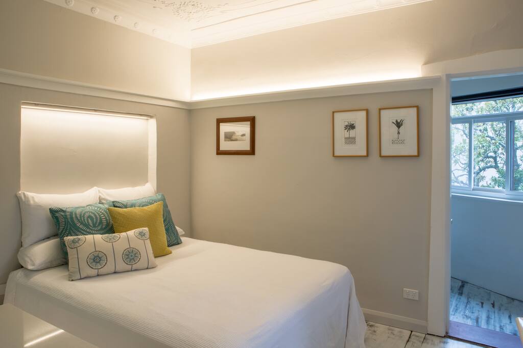Deliciously comfortable queen bed with pure cotton bedding, feather pillows, feather cushions and a feather duvet
