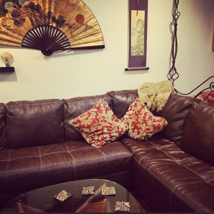 L-Shape comfy leather couch to sleep 1-2 people.