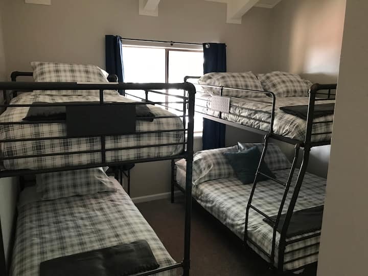 Dormitorio del tercer piso con dos camas individuales más una litera tamaño queen.
