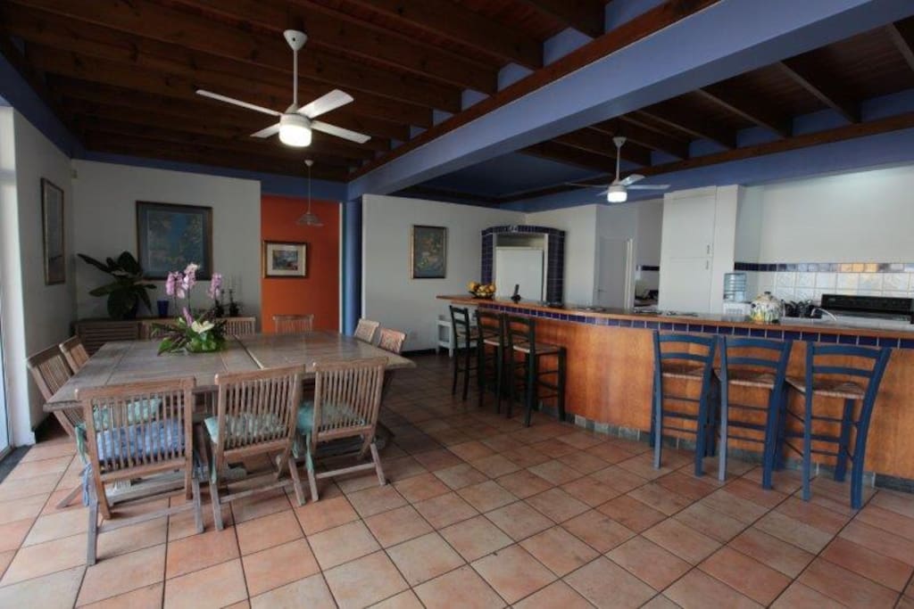 Open plan dining and kitchen area leading to patio with seaview