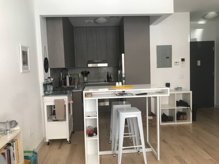 The kitchen, while small, is fully equipped with a stove, oven, refrigerator and dishwasher.