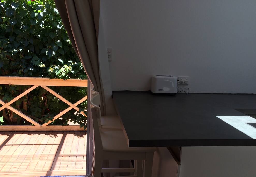 Enjoy the relaxing and peaceful vibe at our built in breakfast bar. The flowering Bougainville and sunshine really add to the ambiance.