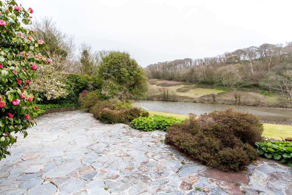 Higher level patio overlooking lake towards National Trust woodland