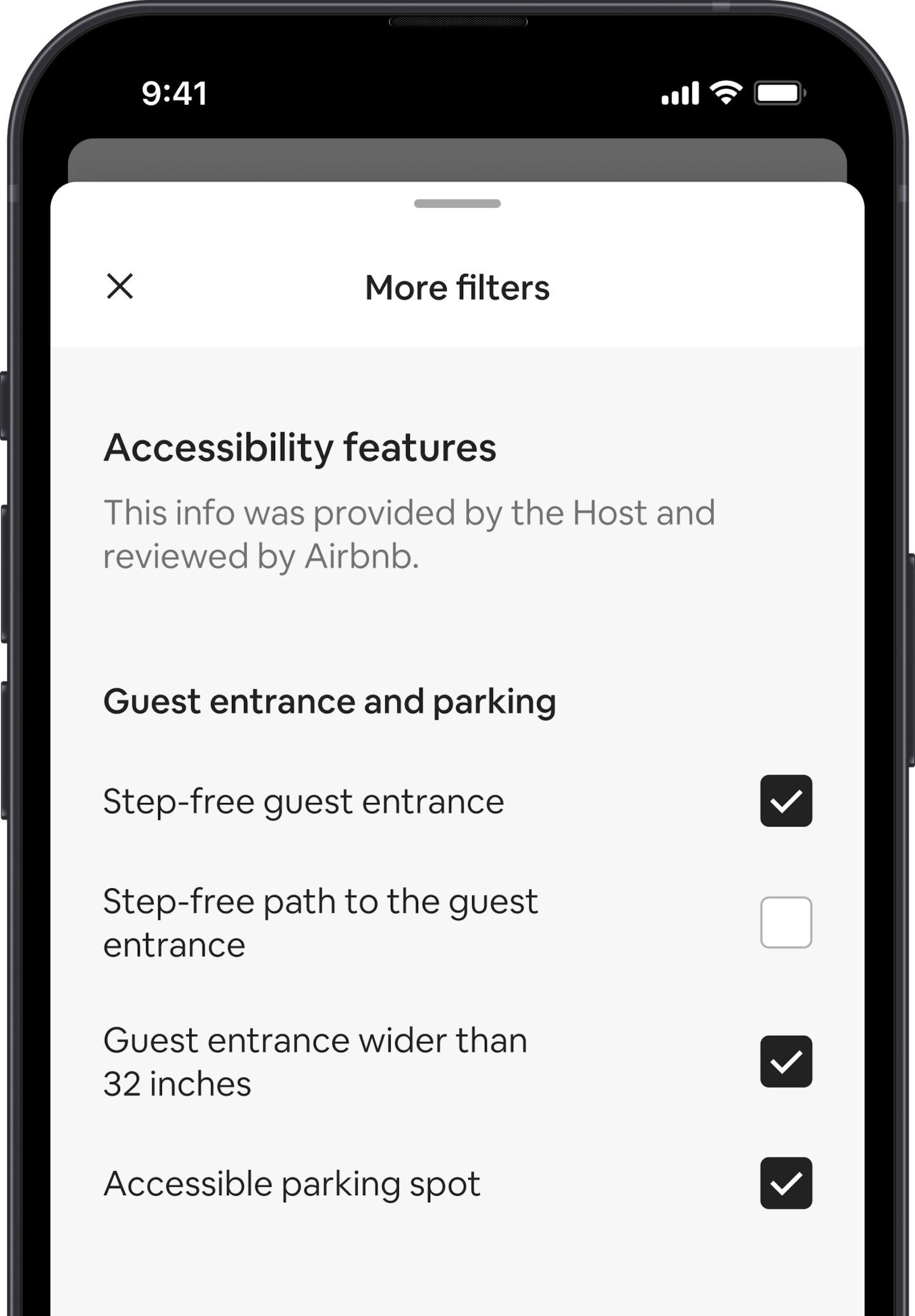 A mobile phone displays the More filters overlay, which is one of many search filters. There is a section heading that reads "Accessibility Features." Below that accessibility features are grouped by areas like “Guest entrance and parking.” There are checkboxes where you can select as many features as you want.