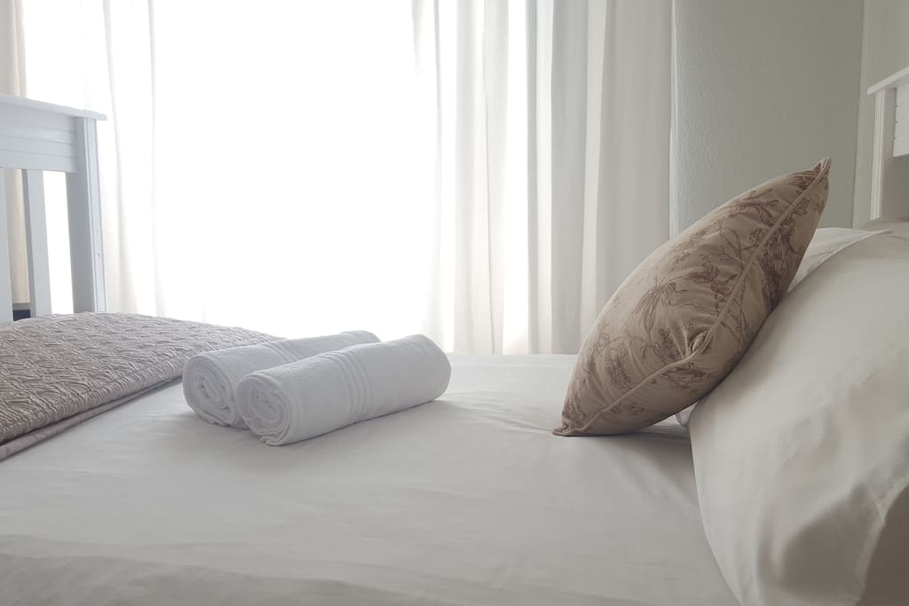 Your modern and spacious bedroom comfortably caters to your needs with a large wardrobe, work area, space for luggage, and heater and fan.