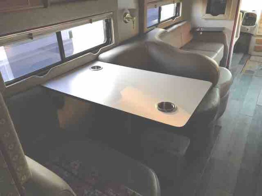 Dinnette table w storage above (glasses & cups here) and below (dish pan). Sofa folds out for bed.