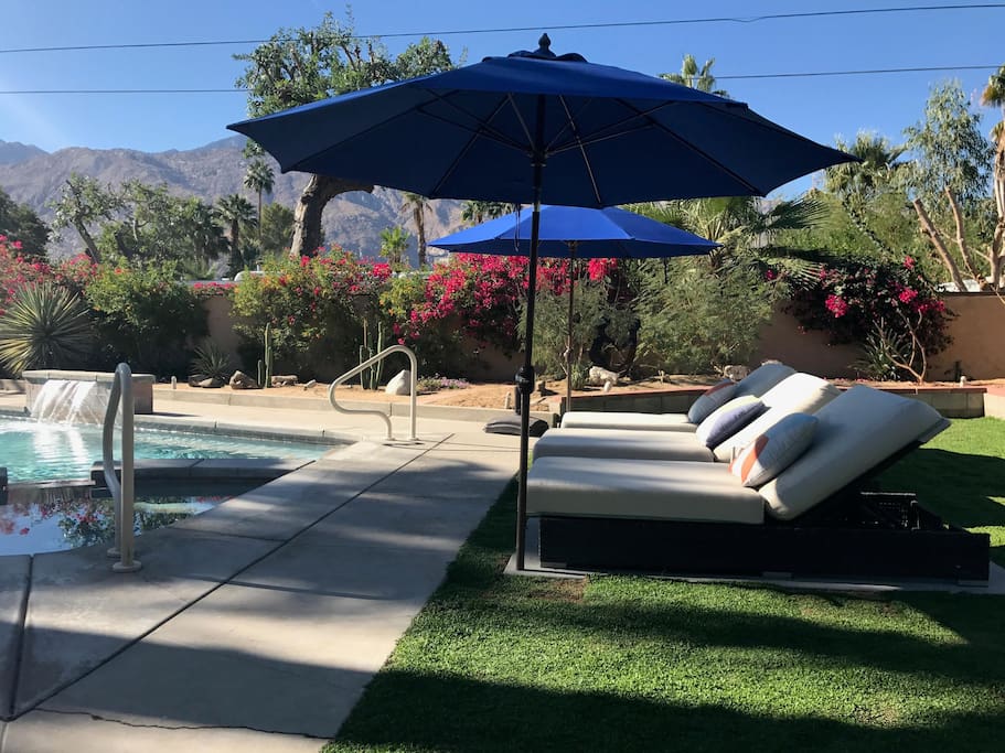 All new backyard redo as of 10/17! Work on your tan or relax in the shade as you drift away on one of the bed-sized loungers underneath the new lush grass, to the peaceful sounds of the waterfall.