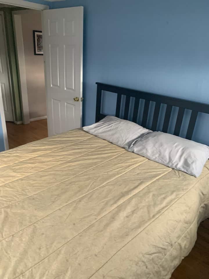 Queen sized bed in bedroom.