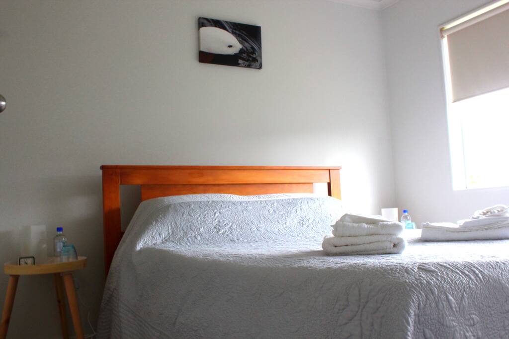 sunny bedroom which looks out to drive . This queen bed has a memory foam gel topper to ensure you get a lovely nights sleep.