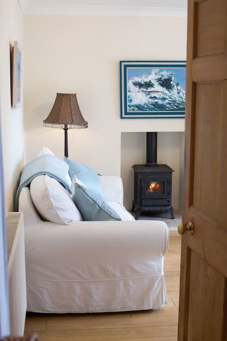 Comfortable sofa-bed and gas fire.