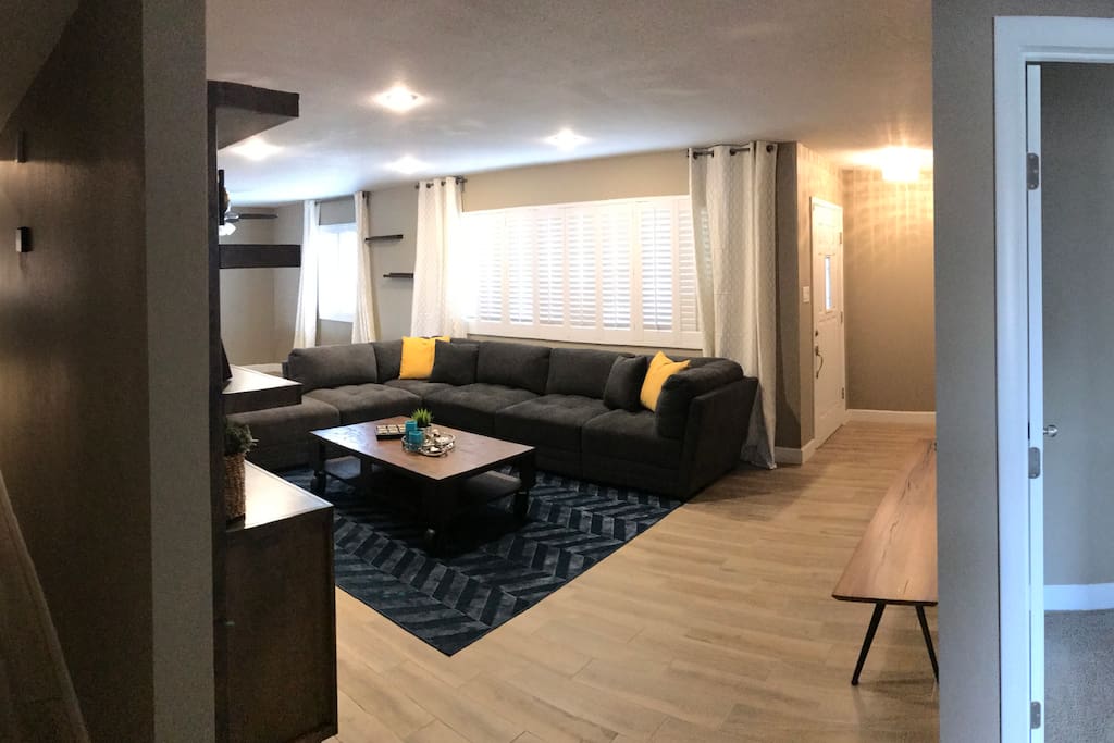 Spacious living area with sleeper sofa, TV.