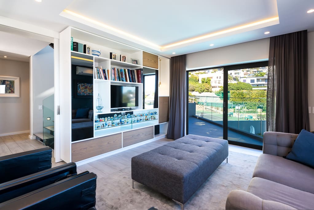 TV room next to entrance hall lounge - leads to rear balcony
