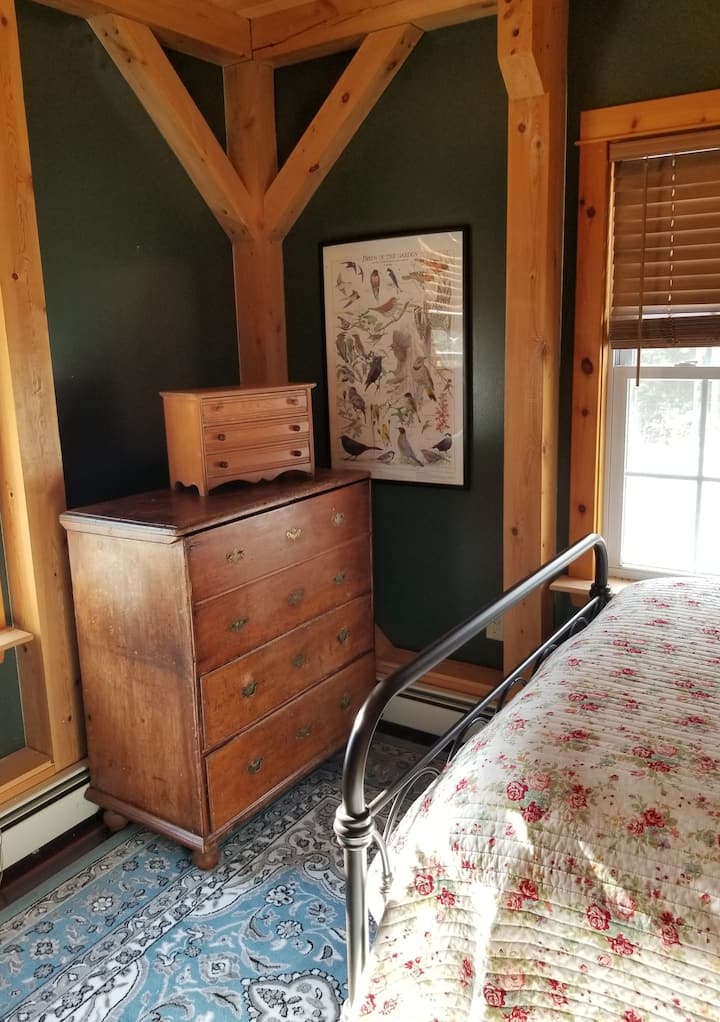 First floor bedroom with a full size brass bed, 4 drawer bureau, antique blanket chest, and a closet. 