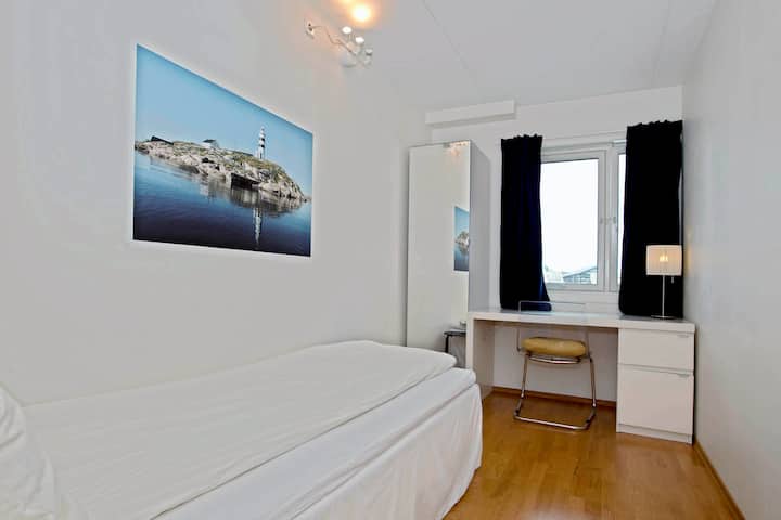 Bedroom 2 with a single bed and a desk.

NB!
After this photo was taken, a monitor has been installed at the desk, allowing for the usage of the room as an office. A printer and keyboard can be found in the cabinet.
