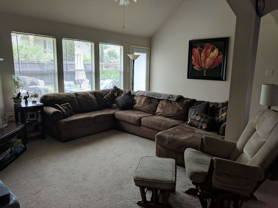 family room with vaulted ceilings looks out into backyard.