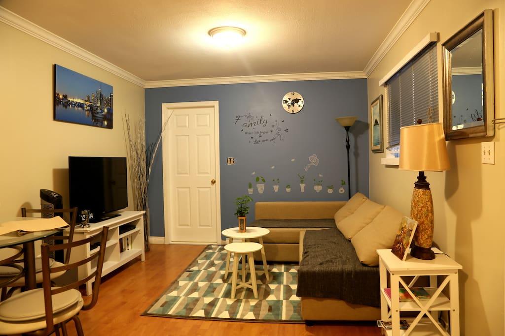 Spacious and bright living/dinning area. Behind the white door is a large bedroom.