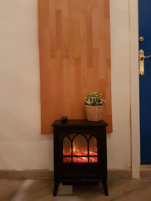 The moving realistic light-illusion fire place also delivers heat if desired