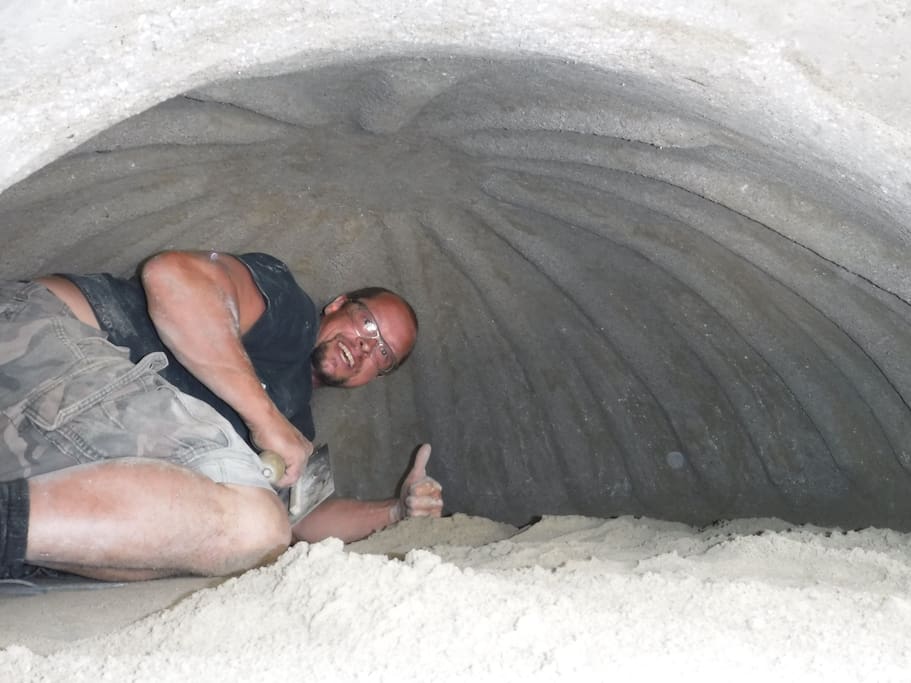 Mason Mike demonstrating the huge size of the interior of the pizza oven.