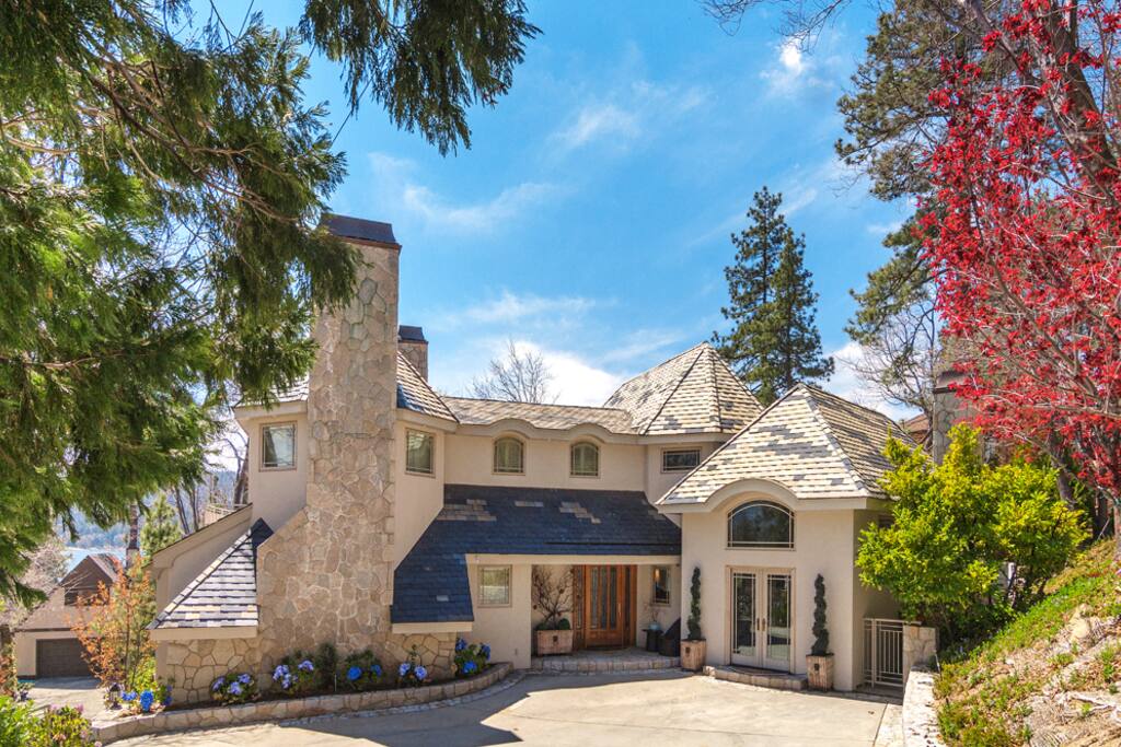 Front of house showing upper driveway with parking for 4-5 cars. Lower driveway parks 3