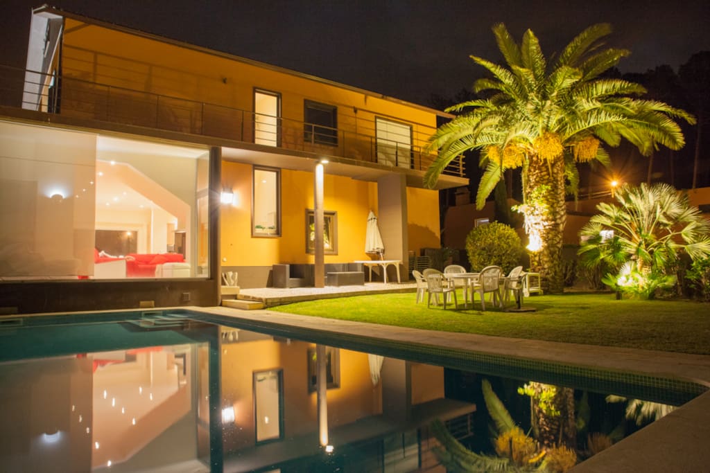 Night pool view of Main house