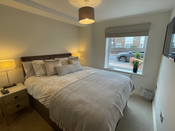 Beautiful double bedroom with wall mounted TV, fitted wardrobes, blackout blinds and illuminated bedside Cabniets 