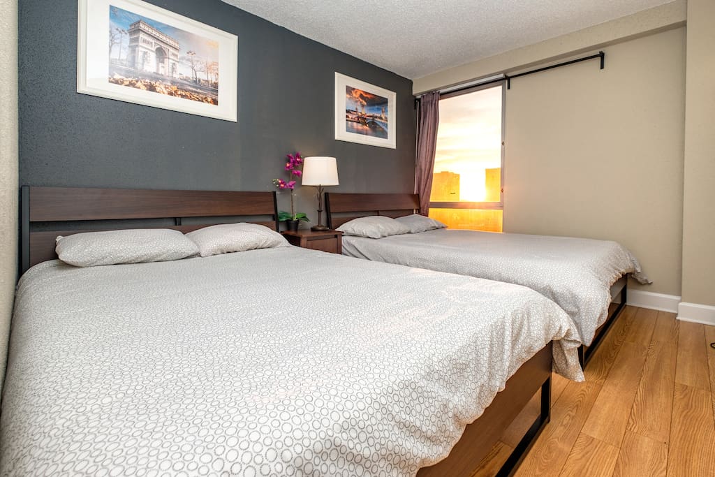 The second bedroom also includes two queen size beds with luxurious sheets for a restful night's sleep.