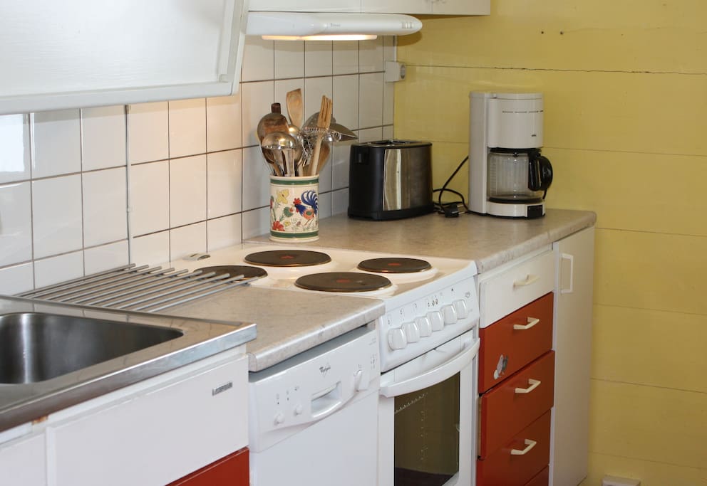 Kitchen with electric stove, fridge, dish washer and microwave.