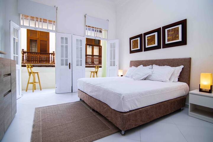 Master bedroom with a huge private balcony with a beautiful view of the colonial street.