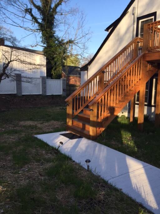 Back sidewalk that leads to the deck and entrance.