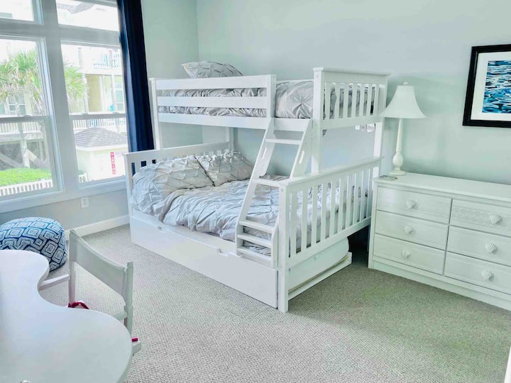 Twin over full plus trundle and private bath and a desk with monitor/TV. Perfect for a 3rd couple or kids.