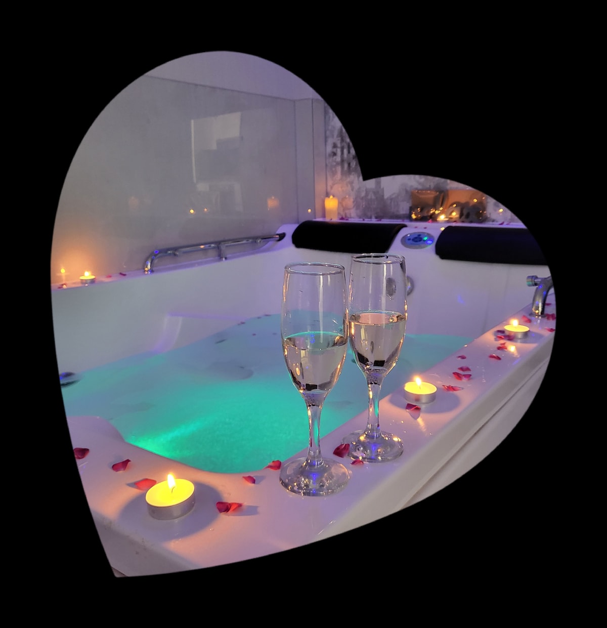 A modern jacuzzi is displayed, featuring soft aqua lighting and surrounded by flickering candles. Two glasses filled with sparkling drink are placed elegantly on the edge, enhancing the relaxation setting. Rose petals are scattered around, contributing to a serene atmosphere.