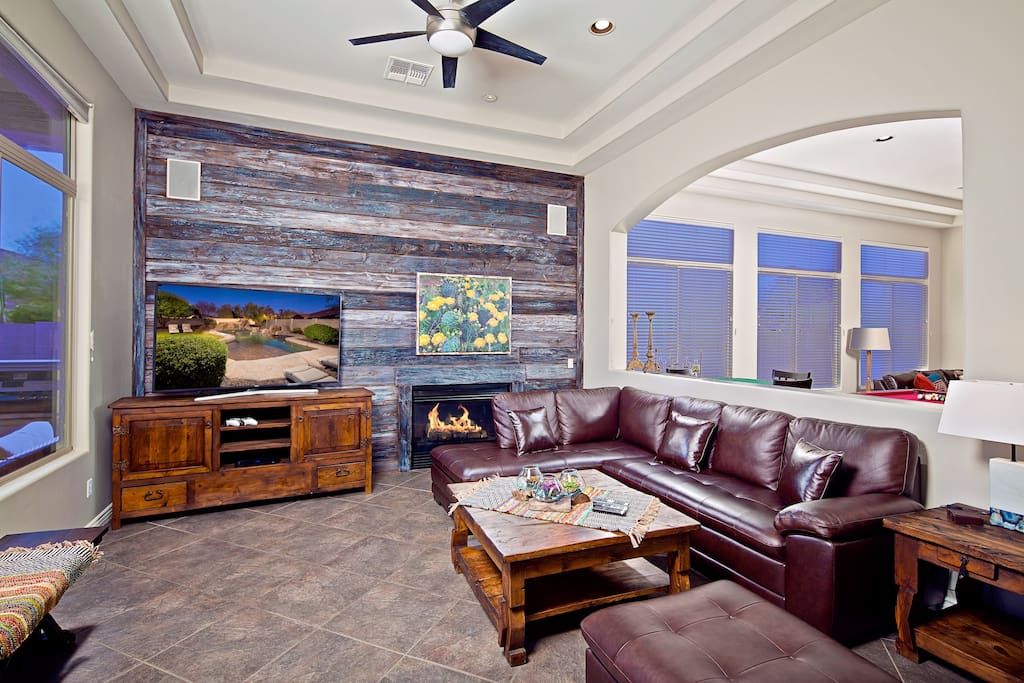 Formal living room with large hd tv and cozy fireplace.
