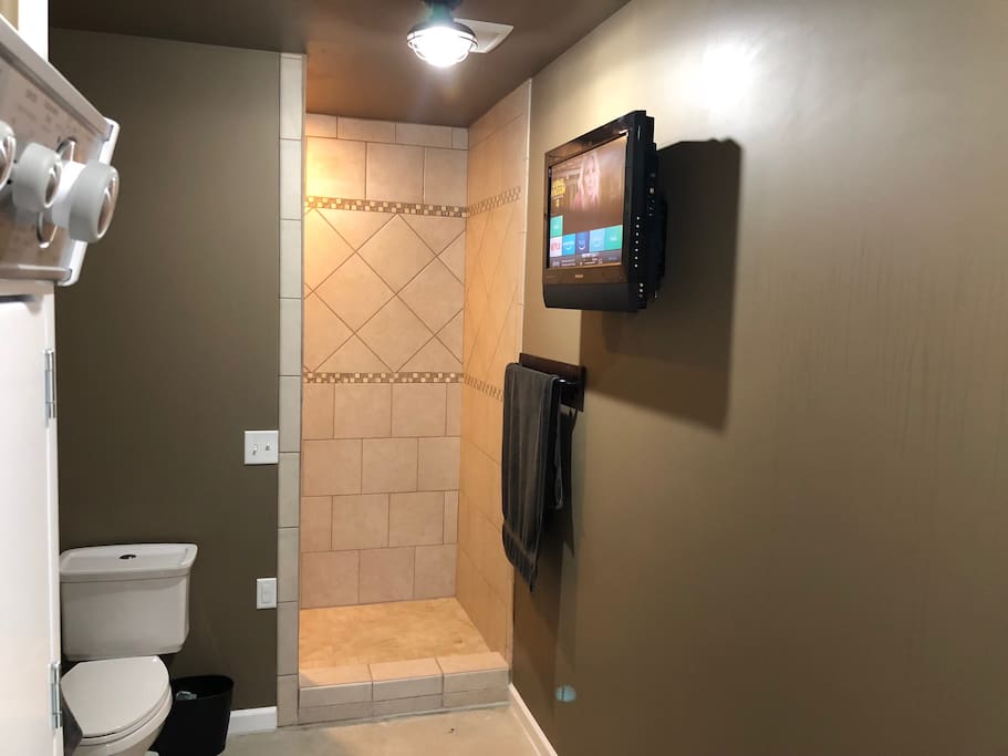 Bathroom has washer/Dryer large custom tile shower and YES a TV