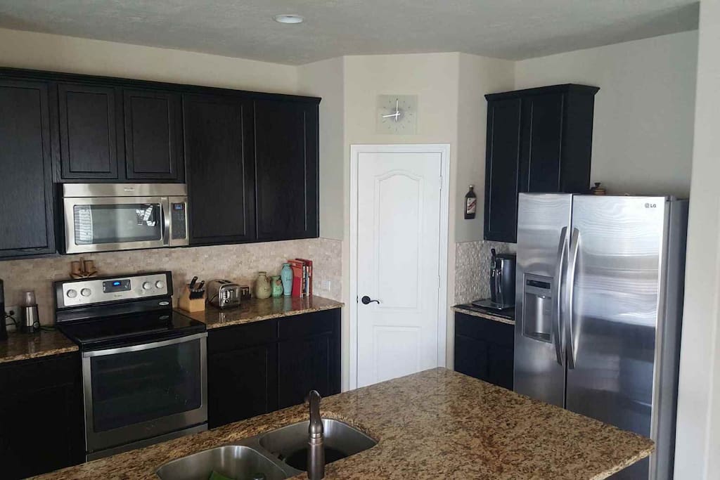 Full kitchen with all stainless steel appliances.