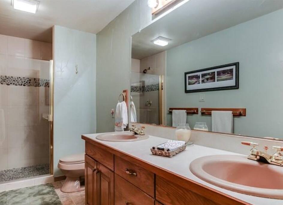 Private bathroom with double sinks and standup shower right next to the bedroom.