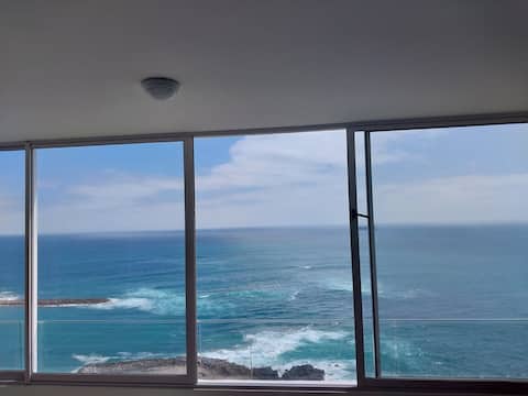 An apartment with an ocean view in front of the beach