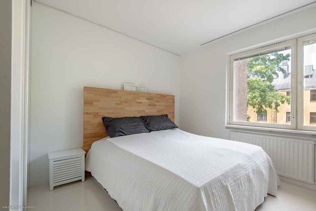 Spacious bedroom with large king size bed and flatscreen TV.