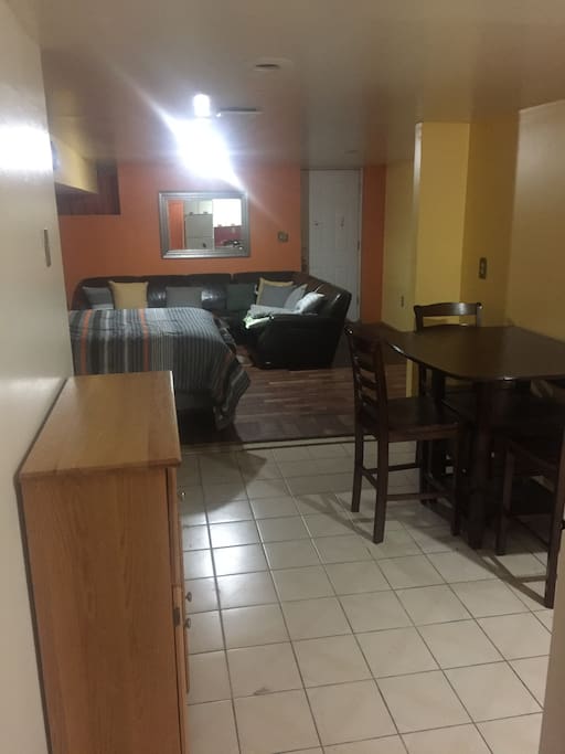 Studio with full bed, couch and dresser.