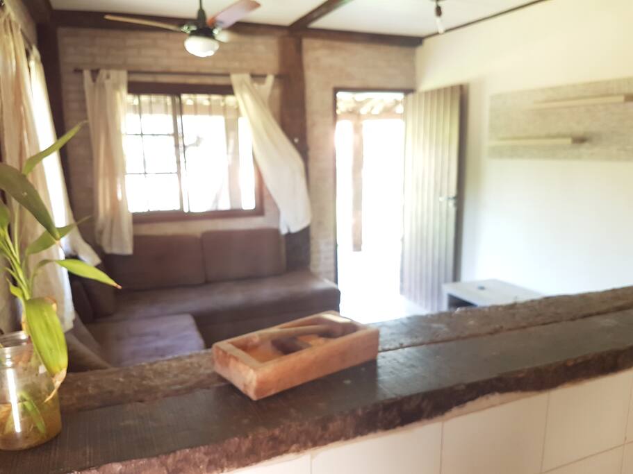 Sala em estilo rústico com dois sofás-cama e ar condicionado.