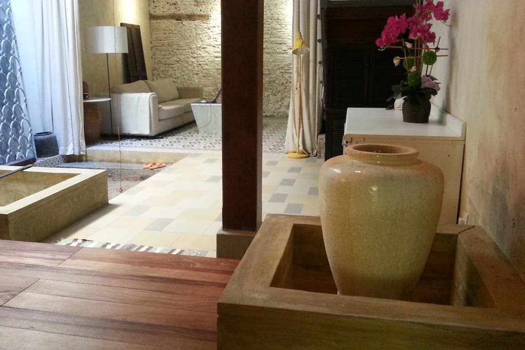 Tasteful shophouse interior. Living space with natural cooling airwell on ground floor