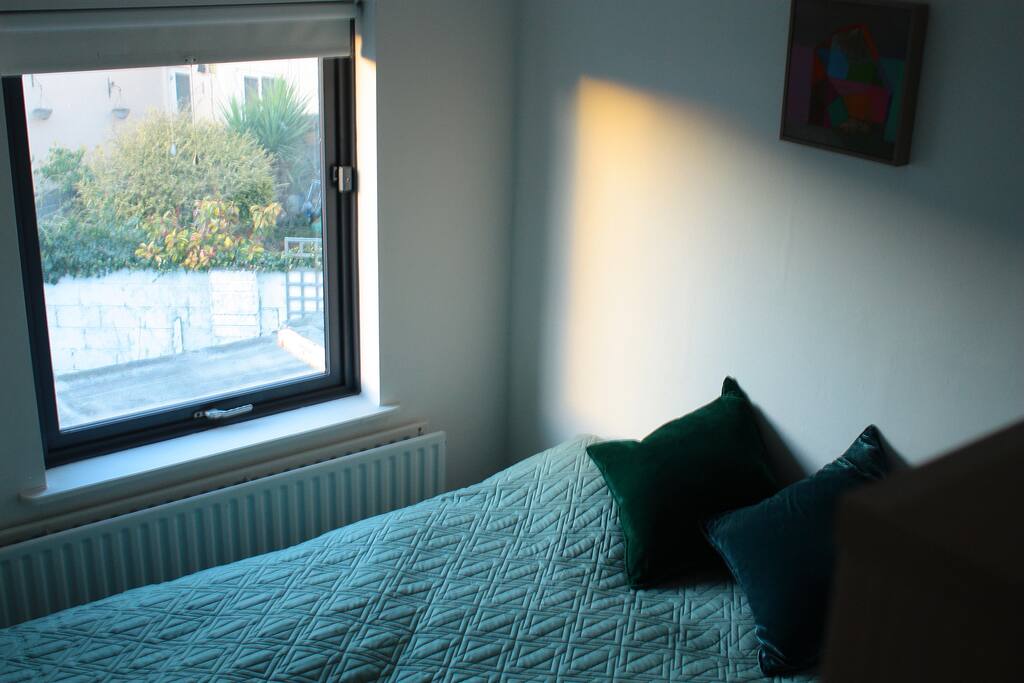 Bedroom looks out onto back gardens.