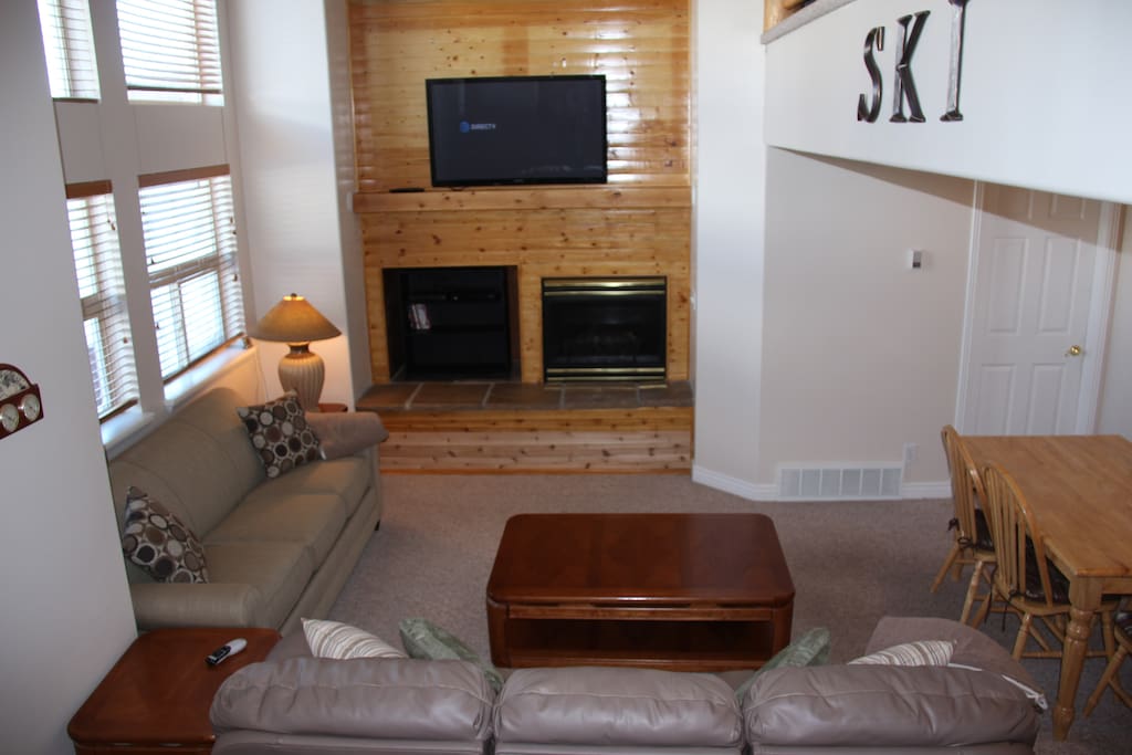 Living space with 2 couches (one sleeper), fireplace and large screen TV