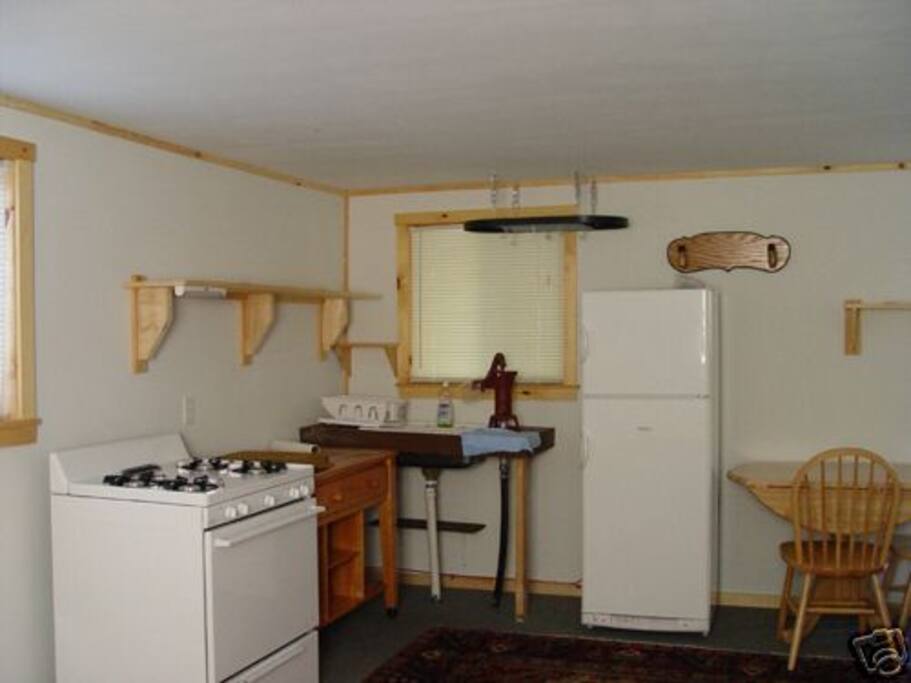 Kitchen with working well pump getting your own water from the brook.