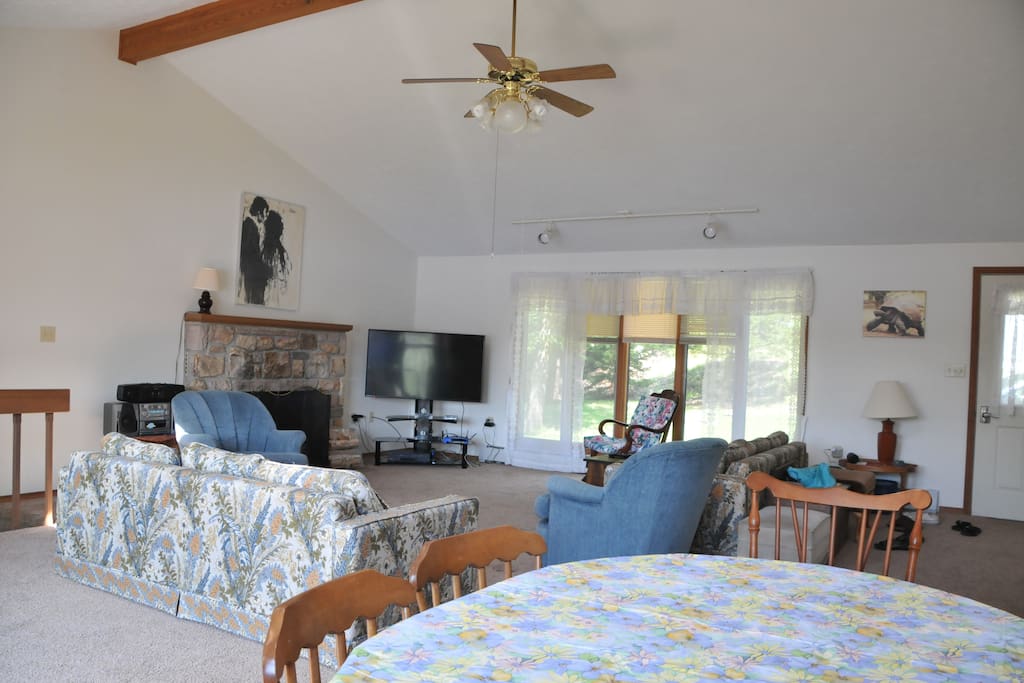 Living room with a fireplace and cathedral ceiling