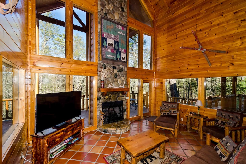 Den with 65 in TV and fireplace