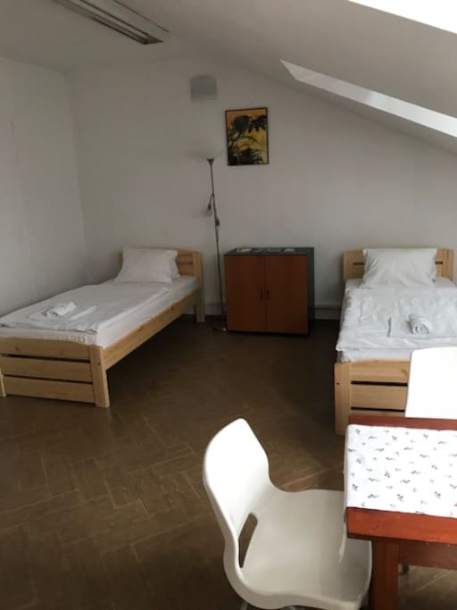 Two single beds, table, chairs, wardrobe